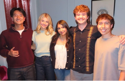 Cast group smiling