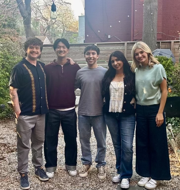 Cast group outside smiling